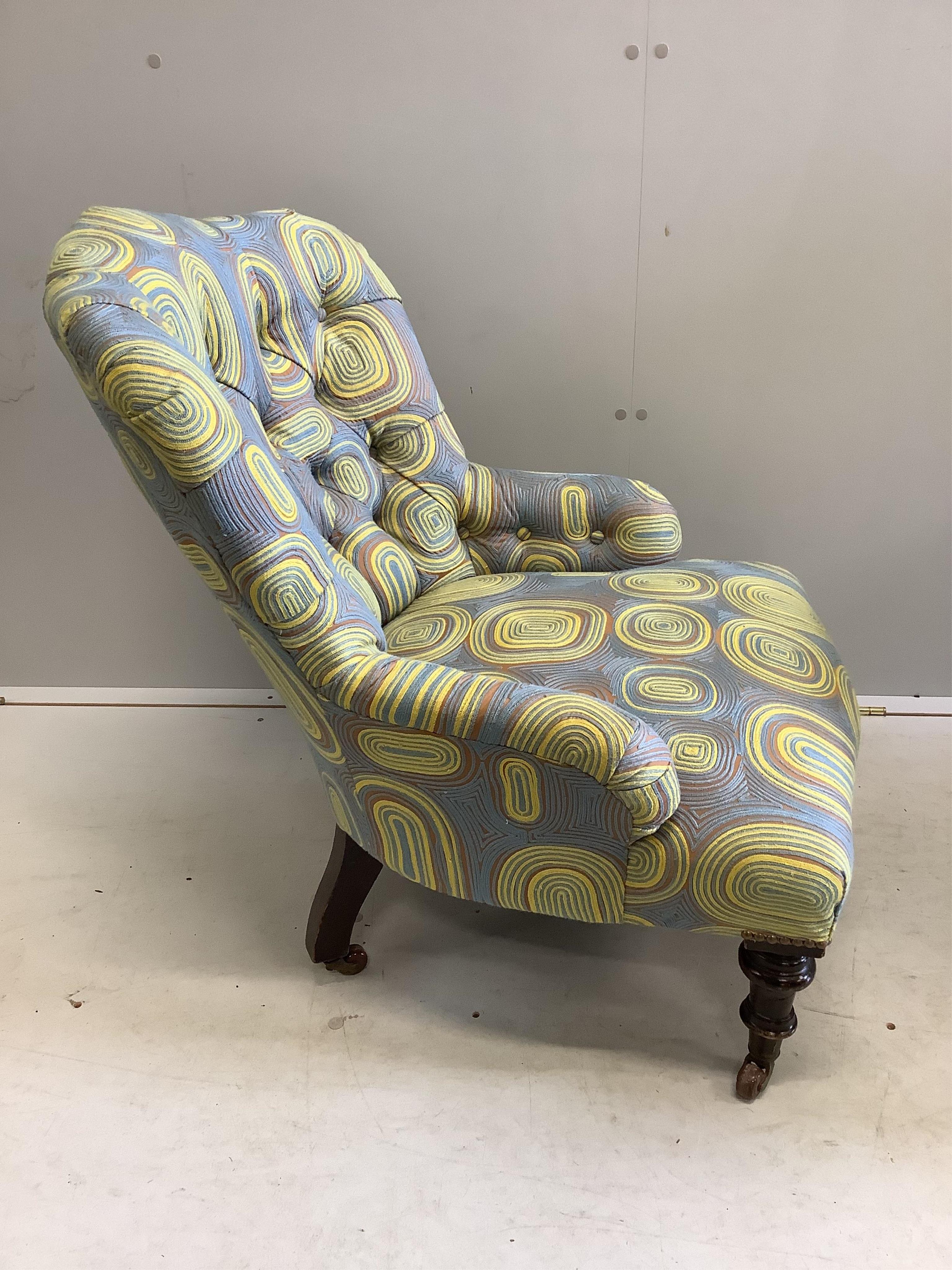A late Victorian nursing chair, recently re-upholstered in a contemporary retro-style fabric, width 63cm, depth 63cm, height 76cm